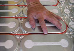 Placing heat cable in the grooves of a HeatShield floor heating insulation panel