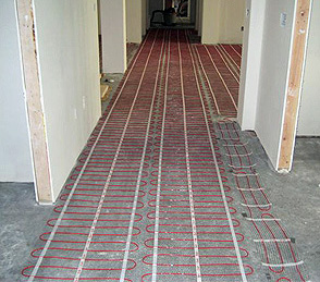 Radiant floor heating mats being installed