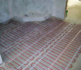 Heating mats being installed to heat a bathroom floor