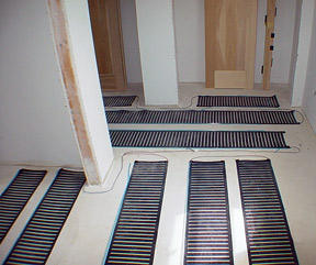 Low-voltage floor heating system being installed