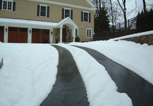 Asphalt driveway with heated tire tracks