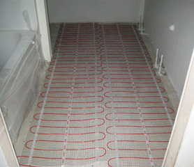 Radiant heated floor being installed in bathroom.