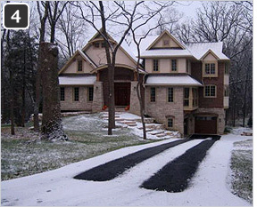 Heated asphalt driveway retrofitted with heated tire tracks.