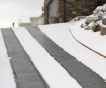Heated driveway on incline with heated tire tracks