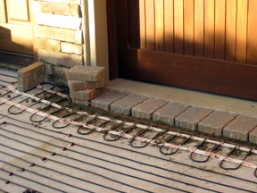 Snow melting mats and cable being installed for heated paver driveway