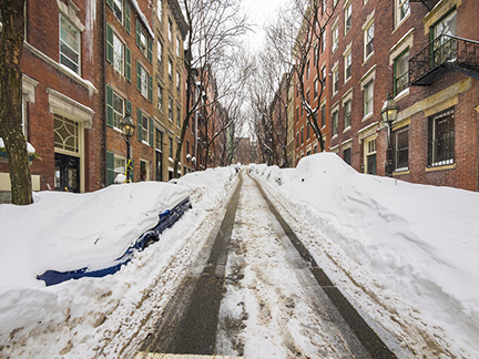 Parked cars in Boston covered with snow after heavy snow storm.