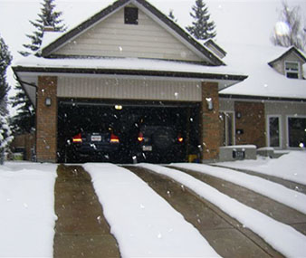 Heated driveway with four heated tire tracks