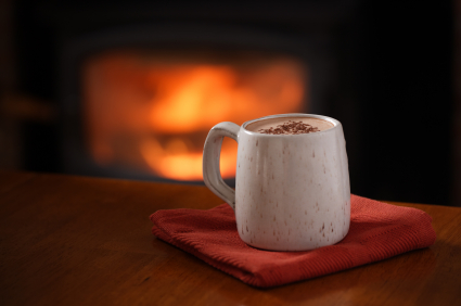A warm mug of hot chocolate by the fire