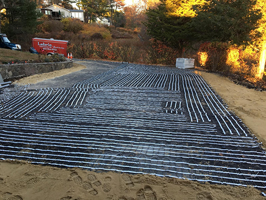 Installing a heated paver driveway.