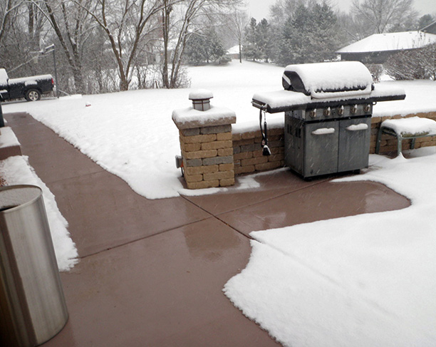 An automated snow melting system heating patio and sidewalks