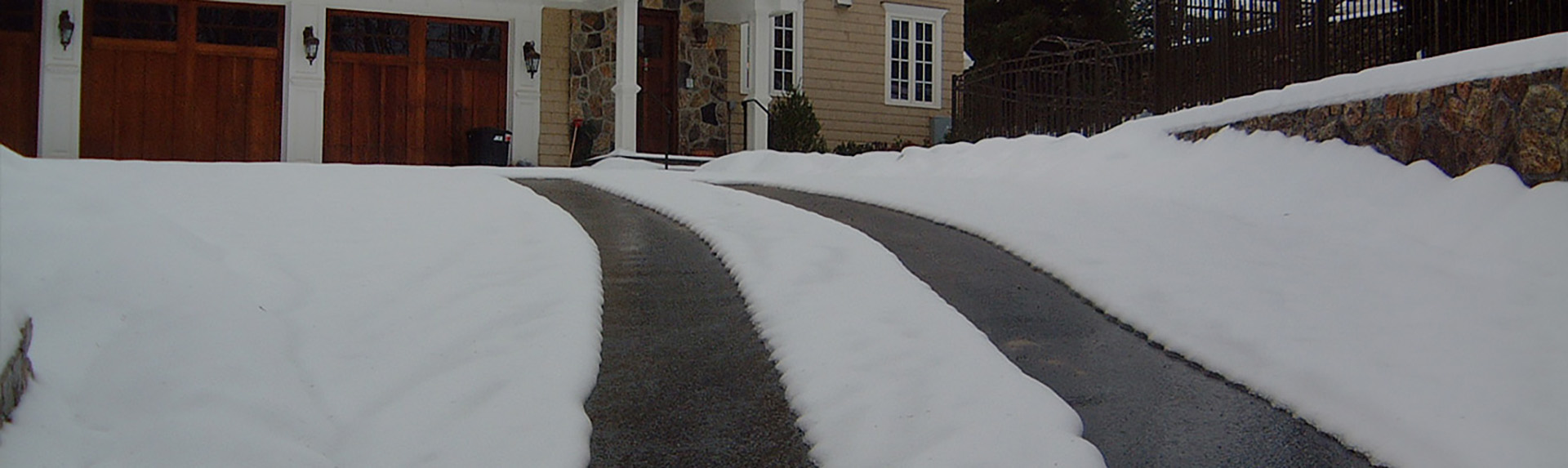 Asphalt heated driveway tire tracks after snowstorm banner