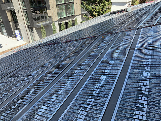 Low-voltage roof heating system being installed.