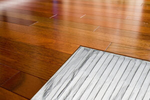 cutaway graphic of foilheat installed under hardwood floor