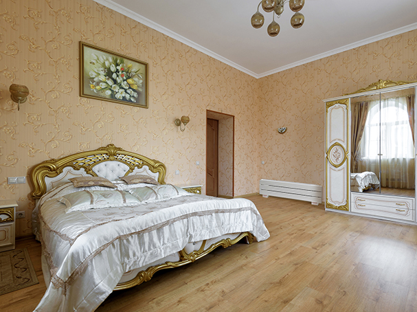 Stylish bedroom with baseboard heater.