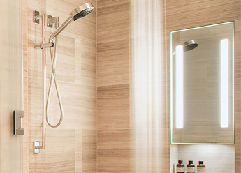 A fog-free shower mirror with LED lighting panels