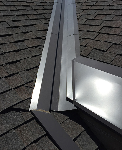Roof panel de-icing system installed to heat valley and roof edge