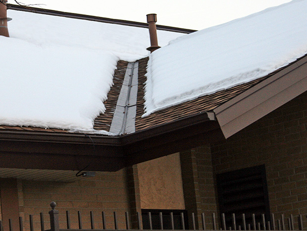 Low-voltage roof de-icing system installed to heat eaves and roof valleys
