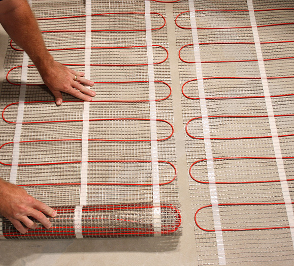 Floor heating mats being installed