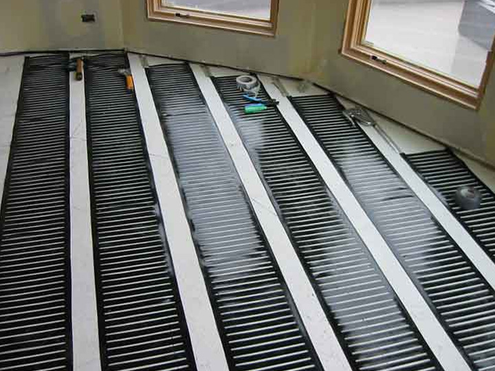 Low-voltage FloorHeat STEP system being installed to heat bathroom floor