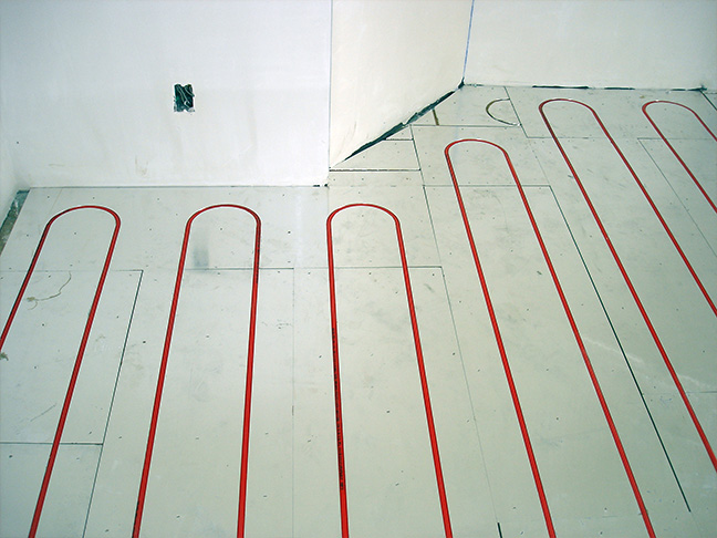 RAUPanel hydronic floor heating system being installed