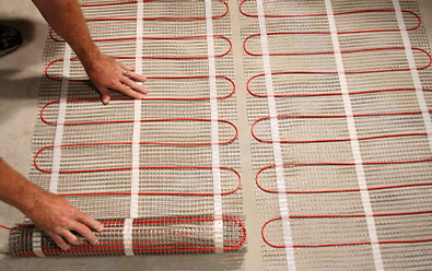 Radiant floor heating mats being installed to heat floor