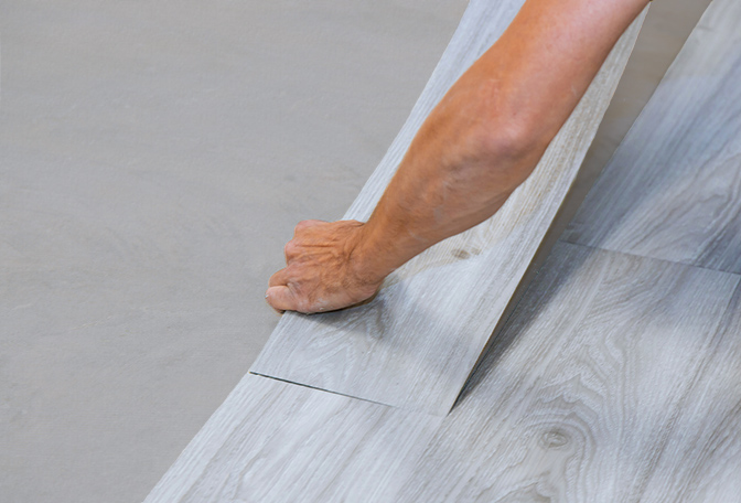 Vinyl tile floor being installed