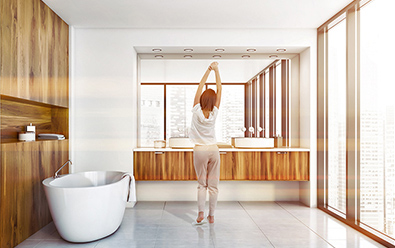 Woman in bathroom with heated tile floor