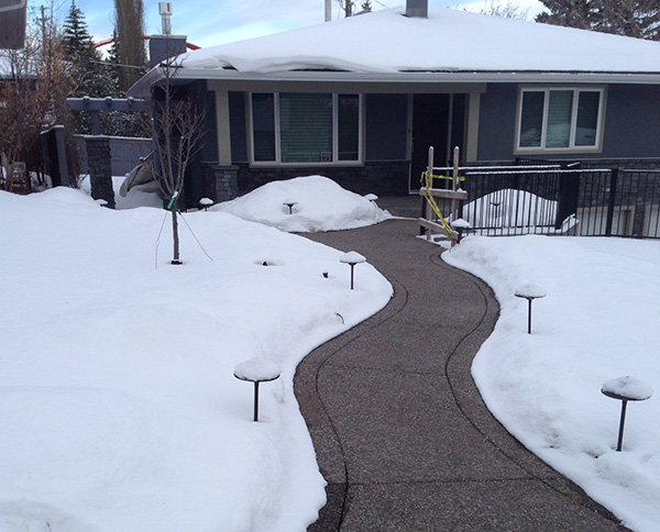 Snow melting system installed to heat sidewalk leading to home