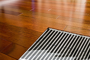 FilmHeat heating floor heating element shown under floating wood floor