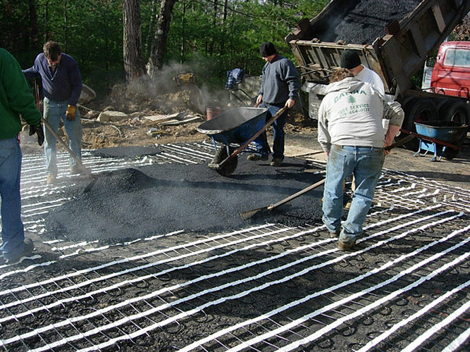 Asphalt heated driveway being installed