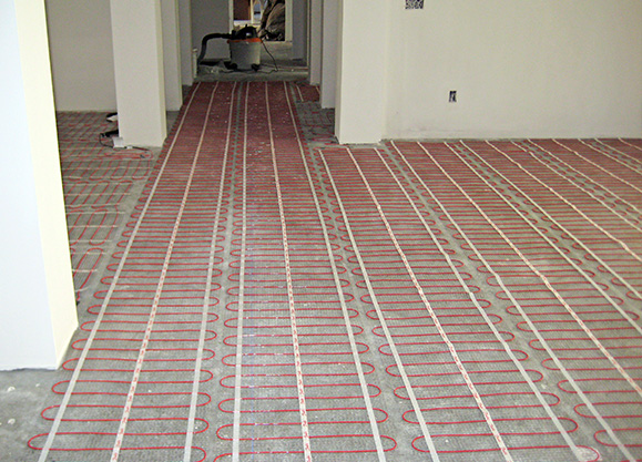 Installing mats for a radiant heated floor