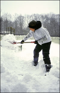 Shoveling snow from driveway.