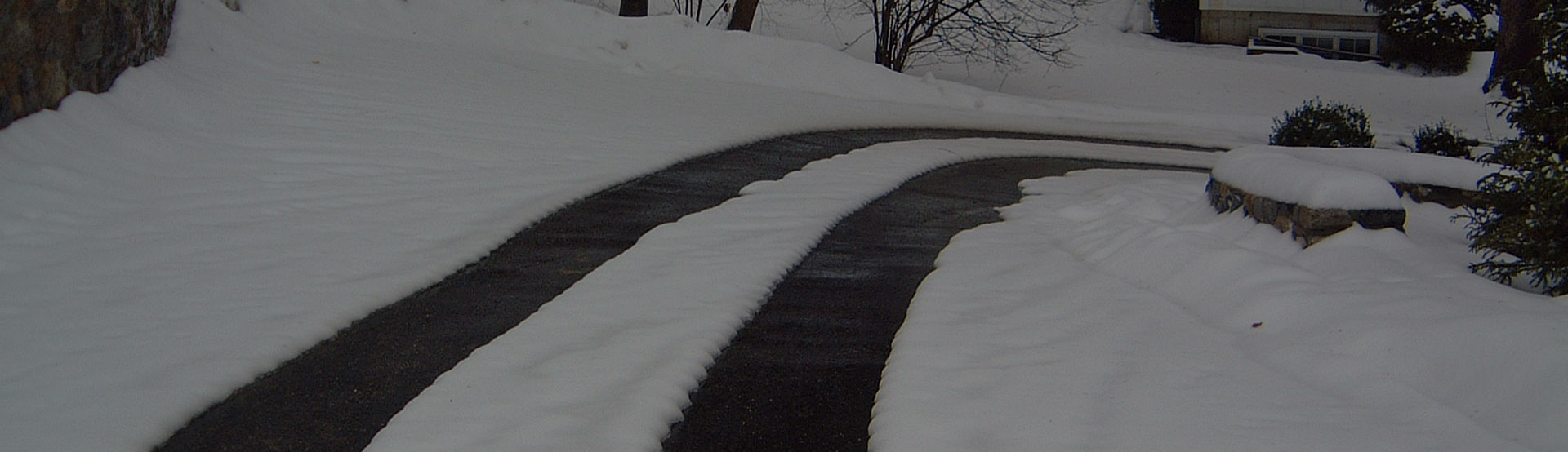 Heated driveway with tire track snow melting system and controls banner