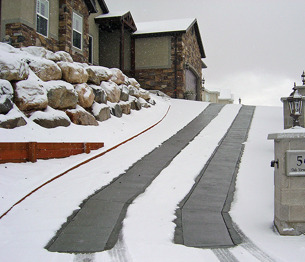 Heated concrete driveway with heated tire tracks