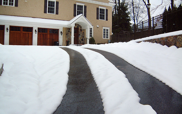 Heated tire tracks in asphalt heated driveway