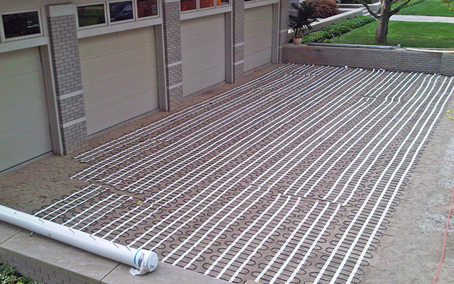 Snow melting mats laid out for heated driveway