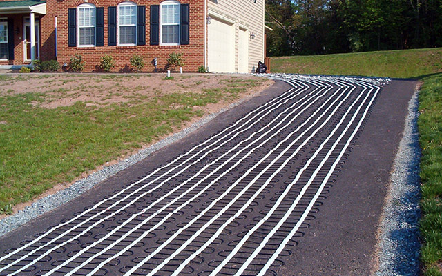 Heating mats laid out for a retrofit asphalt heated driveway