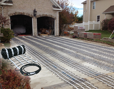 Radiant heating mats installed for a heated driveway