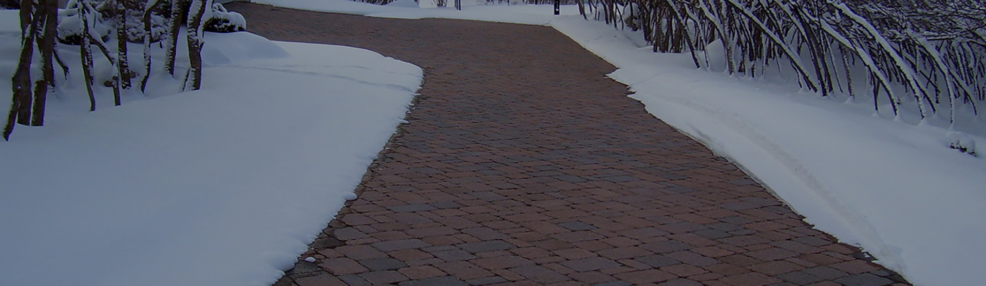 Radiant heated driveway with brick pavers banner