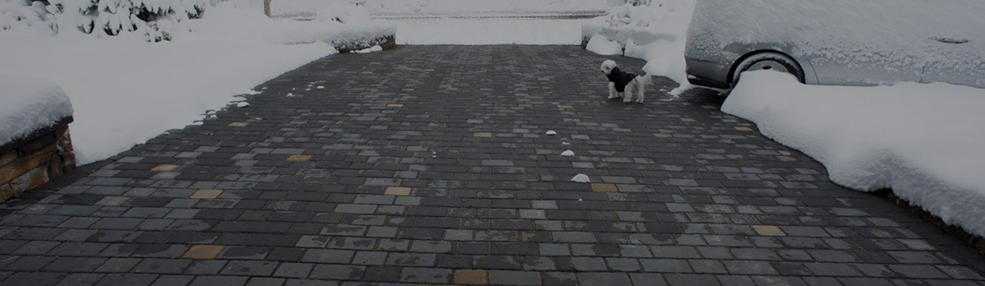 Heated paver driveway after snowstorm banner