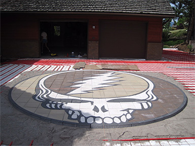 A custom heated paver driveway with Grateful Dead logo