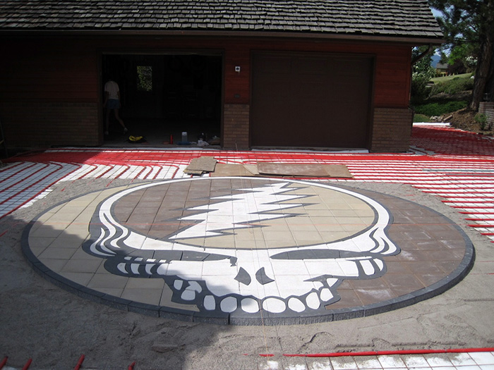 hydronic heated driveway system with Grateful Dead logo being installed