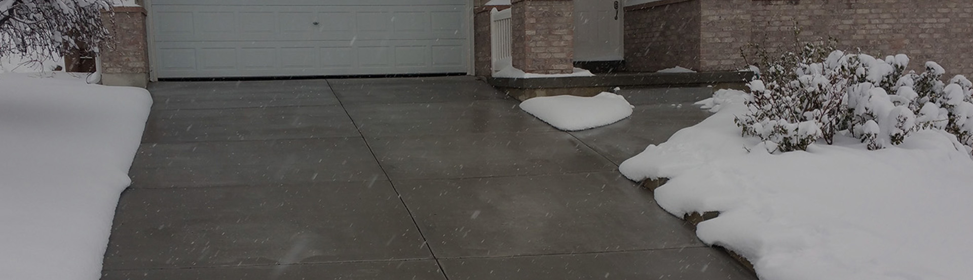 Heated driveway with heated sidewalk banner