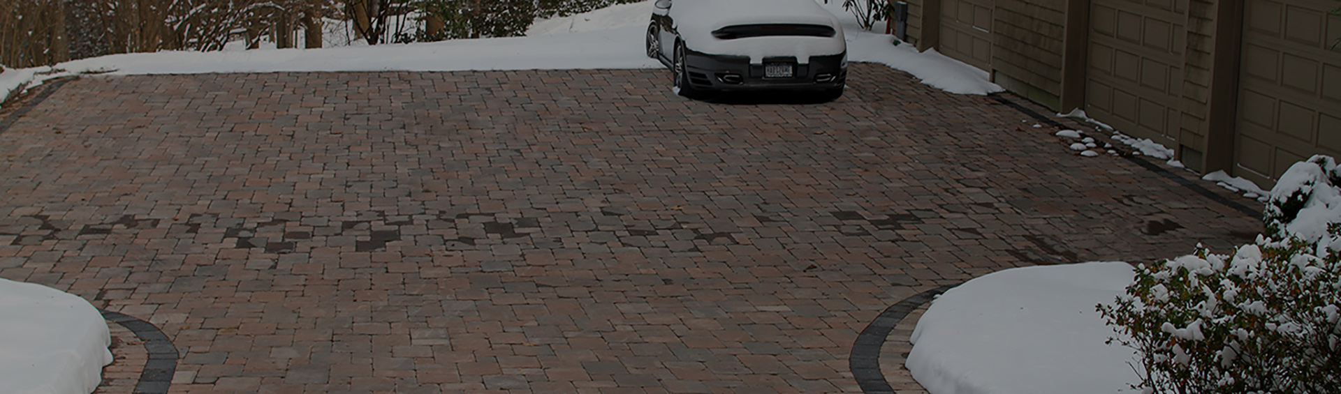 Radiant heat snow melting system installed in residential parking area banner