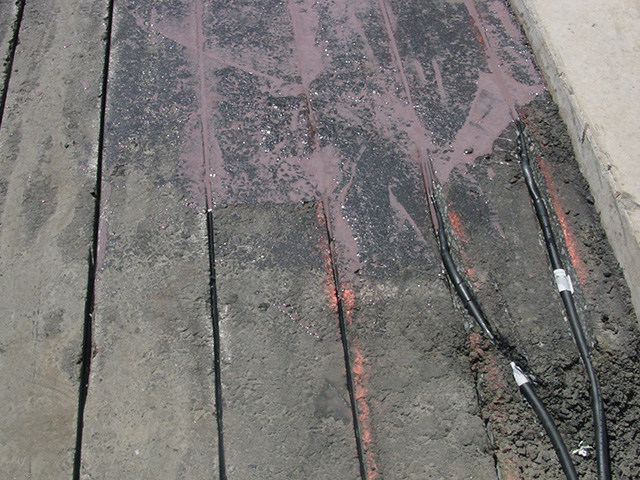 Epoxy being placed over the channels of heat cable